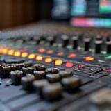 Mixing console with faders and knobs