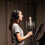 Voice actor speaking into a microphone